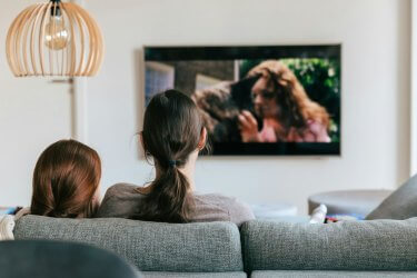 two people watching tv at the pet friendly apts the ellis